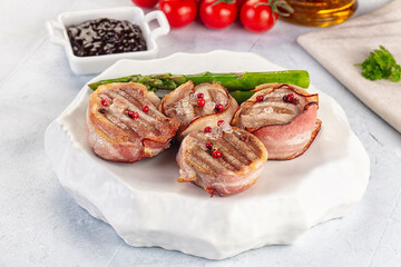 Tasty grilled pork medallion with bacon