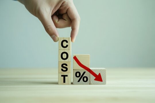 Hand placing cube spelling cost next to percentage symbol with downward arrow indicating reduction