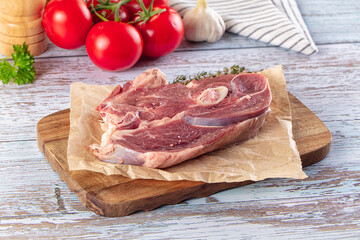 Raw lamb steak with bone