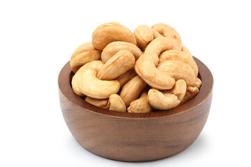 Roasted cashew nuts in a wooden cup. isolated on white background.