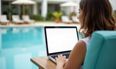 Woman working on laptop by poolside