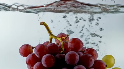 Dynamic Slow Motion: Fresh Red and Green Grapes Splashing into Clean Water, Creating Vibrant Bubbles. - Powered by Adobe