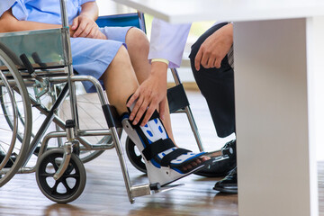 Close up asian doctor physiotherapy check splint leg support to senior old woman patient assisted by caregiver medical orthopedic trauma treatment team providing rehabilitation in a healthcare clinic.