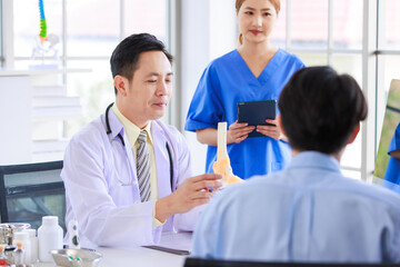 Obraz premium Asian male doctor consulting explain medications to senior female patient assisted by caregiver and nurse professional support trust healthcare checkup, insurance treatment wellness in hospital clinic