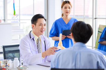 Fototapeta premium Asian male doctor consulting explain medications to senior female patient assisted by caregiver and nurse professional support trust healthcare checkup, insurance treatment wellness in hospital clinic