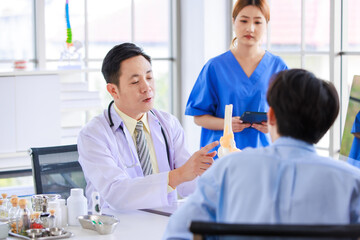 Fototapeta premium Asian male doctor consulting explain medications to senior female patient assisted by caregiver and nurse professional support trust healthcare checkup, insurance treatment wellness in hospital clinic
