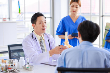 Asian male doctor consulting explain medications to senior female patient assisted by caregiver and nurse professional support trust healthcare checkup, insurance treatment wellness in hospital clinic