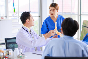 Obraz premium Asian male doctor consulting explain medications to senior female patient assisted by caregiver and nurse professional support trust healthcare checkup, insurance treatment wellness in hospital clinic