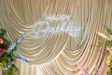 Happy Birthday Neon Sign on Draped Fabric