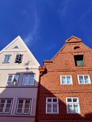 beautiful medieval houses , colorful, street of an old europenean town, blue sky
