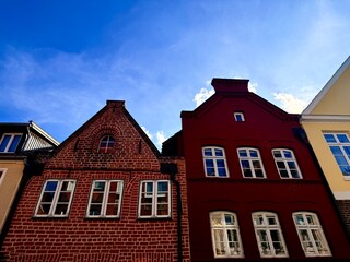 beautiful medieval houses , colorful, street of an old europenean town, blue sky