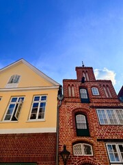 beautiful medieval houses , colorful, street of an old europenean town, blue sky