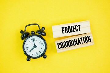 Bell clock and stick with the word Project Coordination. the day-to-day management of tasks within your department. The purpose of coordinating projects is to streamline the workflow of your tasks