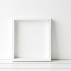 Frame mockup a square white frame resting against a white wall on a white surface in a minimalist setting