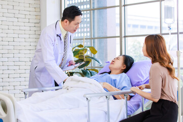 Asian man professional doctor visiting ward, consulting talking to physician, senior woman patient...