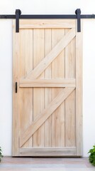 Elegant Light Wood Sliding Barn Door with Black Hardware on a Pristine White Wall, Blending Rustic Charm with Modern Home Design