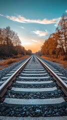 Fototapeta premium Railroad tracks stretching into a colorful autumnal sunset