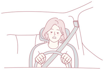 A young driver looks anxious, gripping the steering wheel tightly, highlighting the need for road safety
