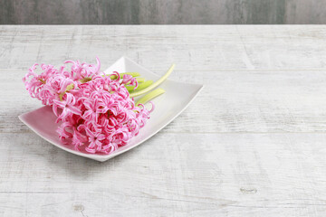 Florist at work: woman shows how to make spring bouquet with tulip, hyacinth and carnation flowers. Step by step, tutorial.