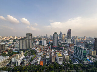 panoramic view of the vast and bustling Jakarta skyline, with a mix of towering modern skyscrapers...