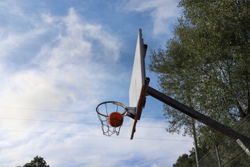 The basketball goes into the basket.