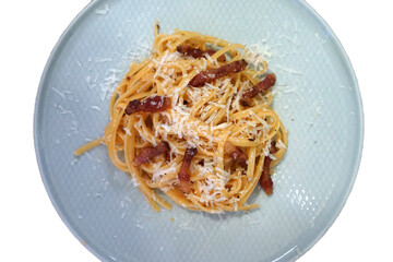 Close up plate of Carbonara Fettucine pasta with crispy bacon bits