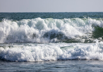 The ocean is calm and the waves are small