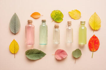 Glass bottle skincare natural ingredient autumn leaf flat lay pastel color cork stopper beauty product wellness organic