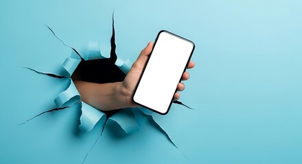 Hand Holding Blank Screen Smartphone Breaking Through Blue Paper

