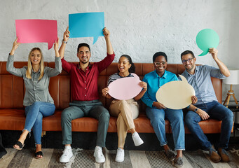 Portrait of a group of young business people in office. Speech bubble, team and comment by business people holding sign, news and voice icon feeling excited on social media. Group, opinion and poll by