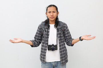 An Asian man wearing casual clothes, backpack, camera hanging around his neck, stretching his arms...