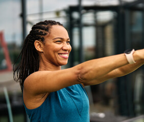 Portrait of a young black woman  exercising in a gym, lifting weights, kettlebell equipment,...