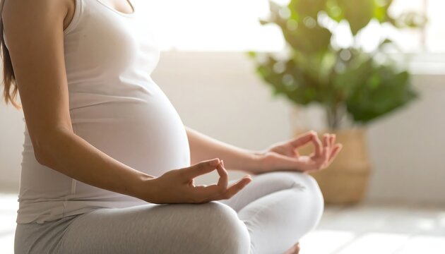 Calm pregnant woman practicing prenatal yoga and meditation for a healthy lifestyle