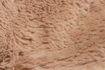 Light brown faux fur close up - fabric texture for clothes, blanket, pillow