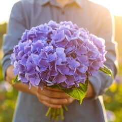 Purple hydrangea bouquet held outdoors