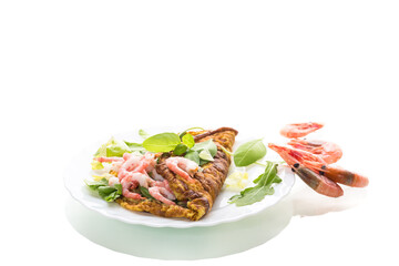 Fried omelette with shrimps and greens on a white background