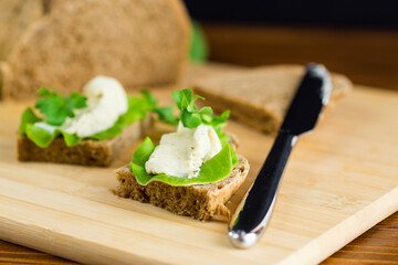 Healthy sandwich with arugula, salad and soft cheese