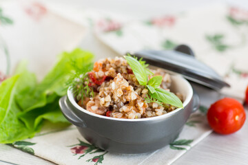 simple dinner. Cooked buckwheat with vegetables in a ceramic bowl
