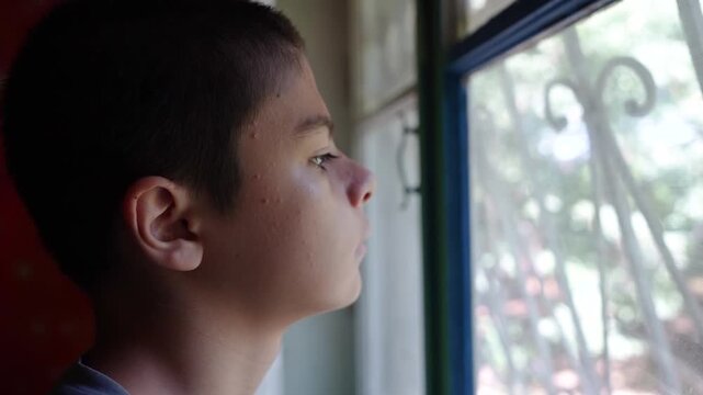 An Autistic Child Looking Out the Window.
