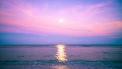 Obraz premium Serene Pink Sunset over Calm Ocean Waves Peaceful Moonlit Beachscape.