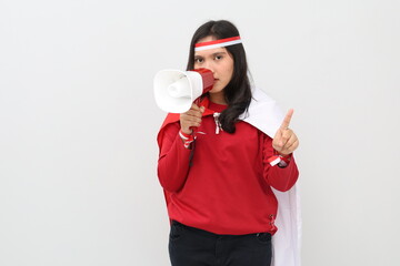 Indonesian woman celebrating Indonesian Independence Day, giving a commemoration using a megaphone...