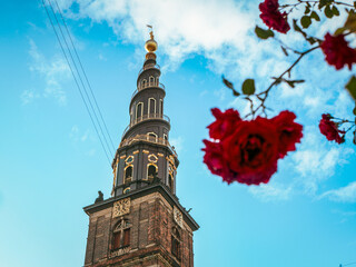 Church of Our Savior’s iconic spiral spire rises against a vivid blue sky in Christianshavn,...