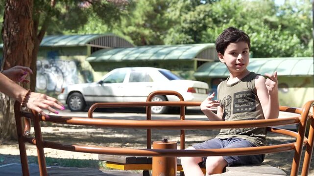 Mother playing with her autistic child in a park Autism support.
