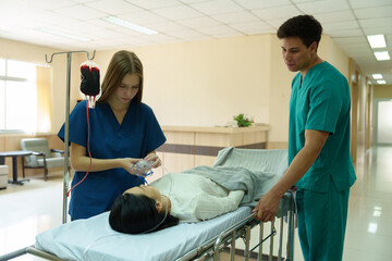 Doctors and nurses are caring for a patient lying in a wheelchair who is in critical condition.