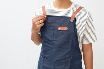 Asian Man wearing Apron in casual stylish clothing, while wearing and tidying his apron, no face isolated white background