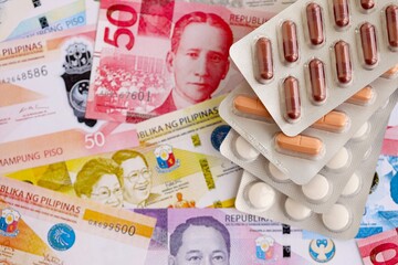 Philippines peso currency money bills and medicine pills. The concept of medicine and pharmacy