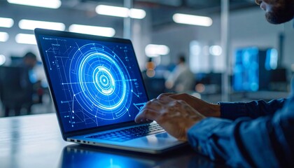 Person Working on Laptop with Futuristic Blue Interface in Office Setting