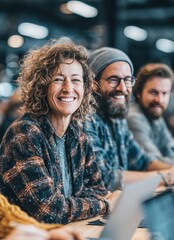 Obraz premium Group of happy designers smiling while working together in modern office