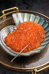 Bright red caviar, a gourmet delight that adds a burst of flavor to any dish or celebration.  grey background. top view