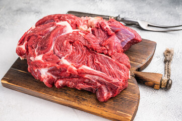 Fresh raw beef neck meat, perfect for slow cooking and creating rich, flavorful stews and hearty dishes. white background. top view